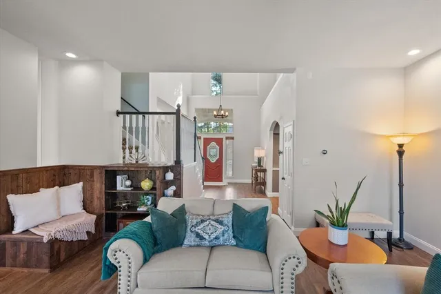 a living room with furniture and a potted plant