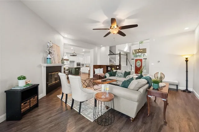 a living room with fireplace furniture and a wooden floor
