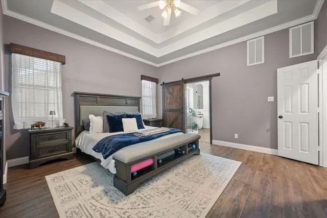 a bedroom with a large bed and a chandelier