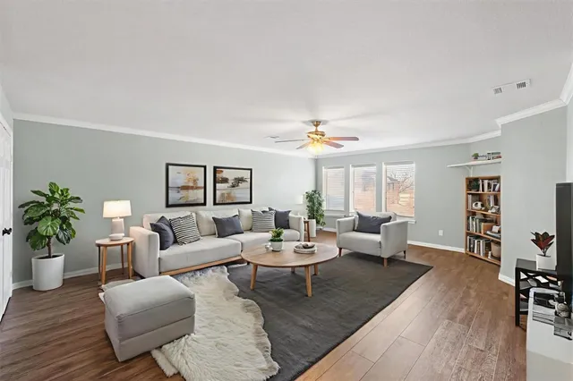 a living room with furniture and wooden floor