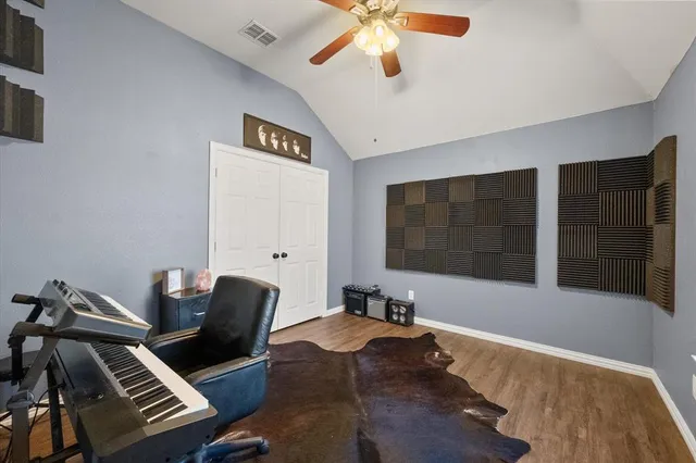 a view of a workspace with furniture and a ceiling fan