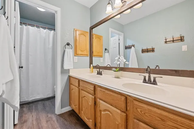 a bathroom with a double vanity sink and a mirror