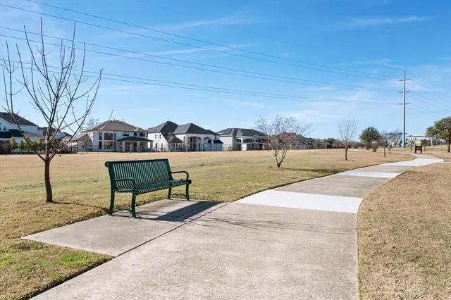 a view of a lake with a bench in front of house