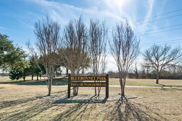 a wooden bench sitting next to a yard