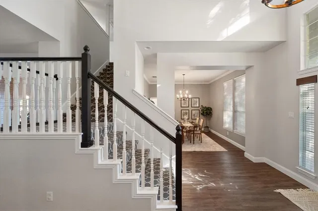 a view of entryway and hall with wooden floor