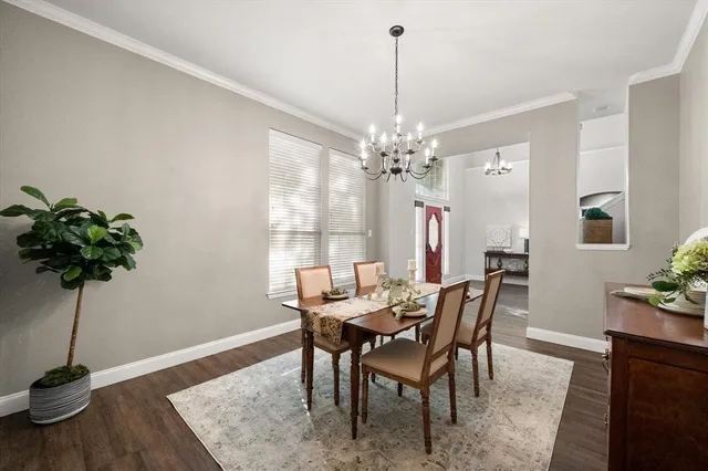 a view of a dining room with furniture wooden floor and chandelier