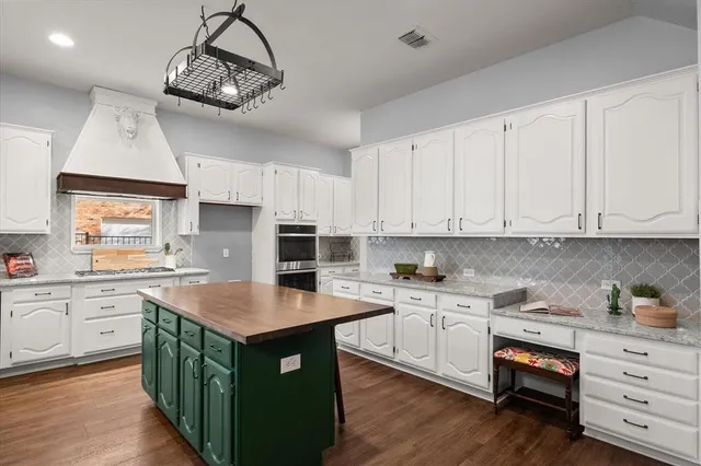 a kitchen with a sink window and cabinets