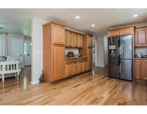 84 Cranberry Meadow Road Spencer, MA 01562 - Photo 14 of 33 a kitchen with stainless steel appliances wooden floor and an empty room