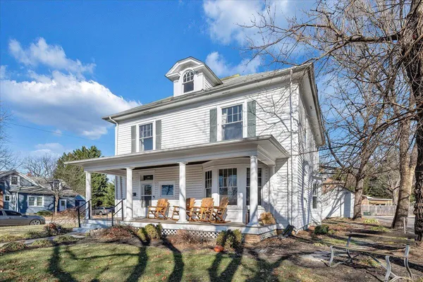 a front view of a house with outdoor seating