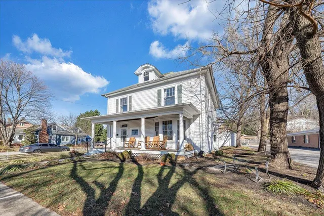 a view of a house with a swimming pool and sitting area