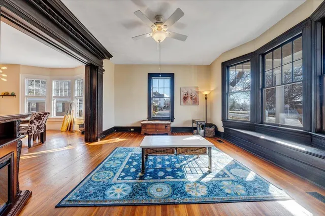 a living room with table chairs and a large window