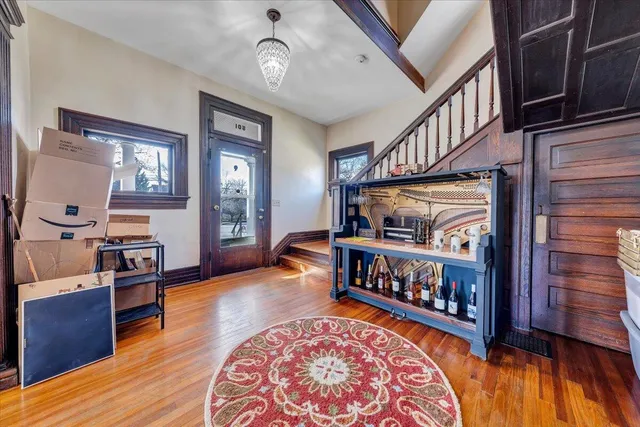 a view of an entryway and hall with wooden floor