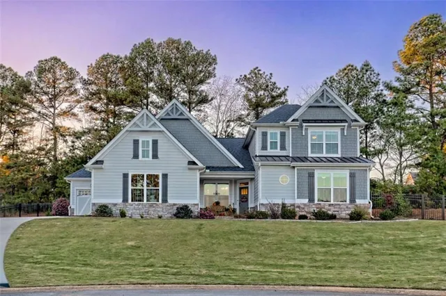 a front view of a house with a garden