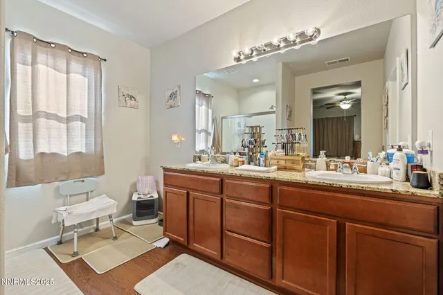 a spacious bathroom with a double vanity sink mirror and toilet