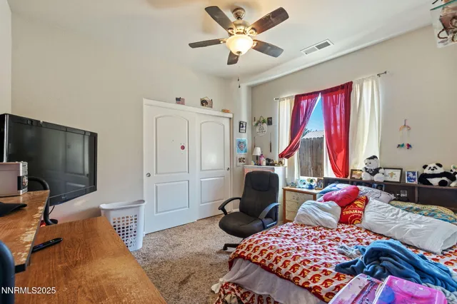 a bedroom with furniture and a flat screen tv
