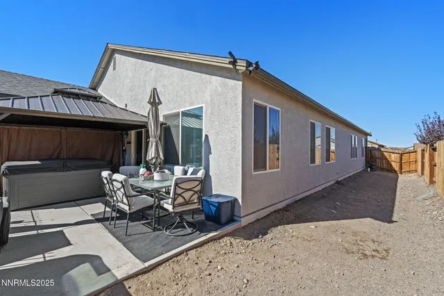 a view of a house with backyard and sitting area