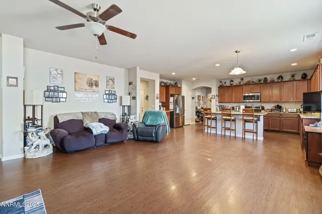 a living room with furniture and kitchen view
