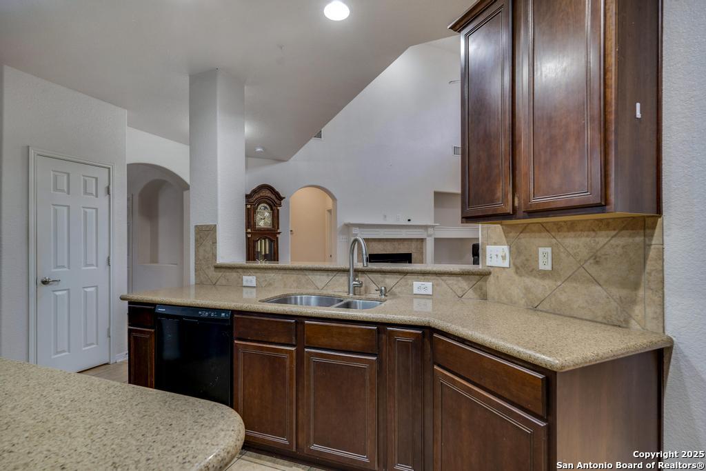 1934 Oak Flat Road San Antonio, TX 78251 - Photo 15 of 33 a kitchen with granite countertop stainless steel appliances a sink and cabinets