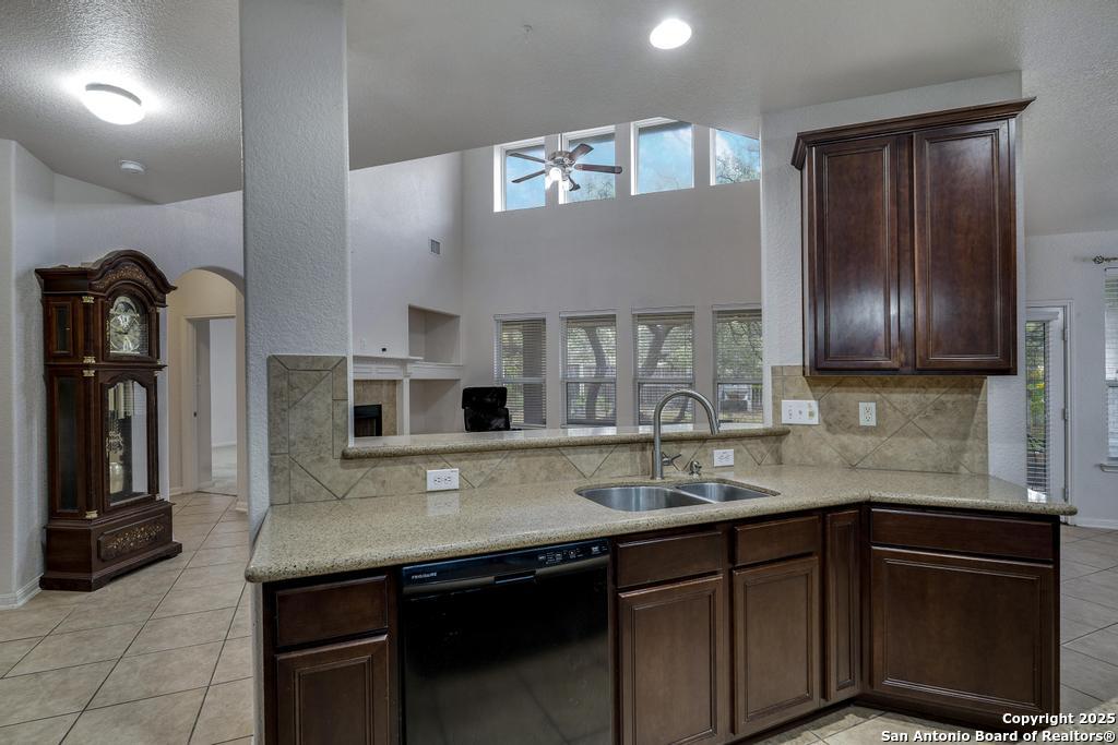 1934 Oak Flat Road San Antonio, TX 78251 - Photo 17 of 33 a kitchen with stainless steel appliances granite countertop a sink stove and microwave