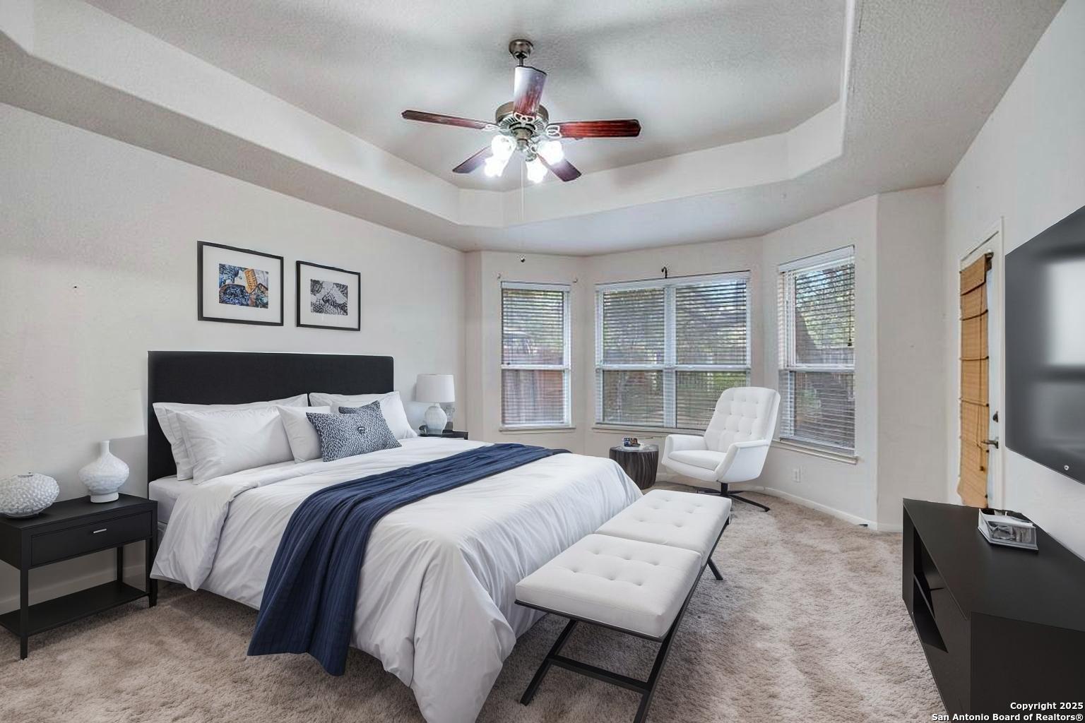 1934 Oak Flat Road San Antonio, TX 78251 - Photo 19 of 33 a bed room with a bed couches and a flat tv screen