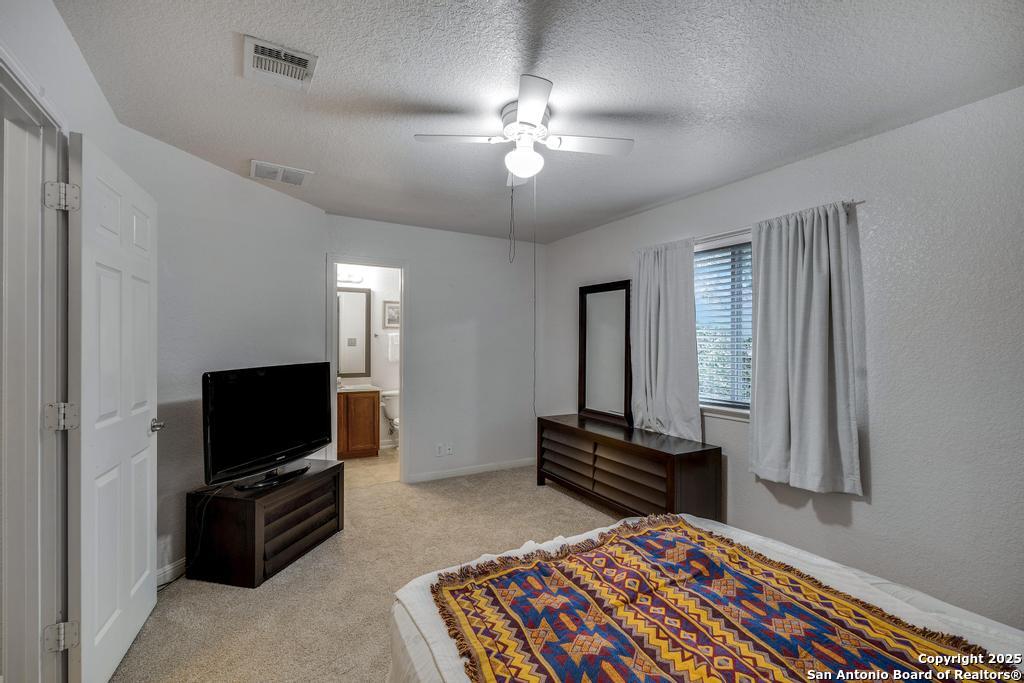 1934 Oak Flat Road San Antonio, TX 78251 - Photo 23 of 33 a living room with a flat screen tv and a couch