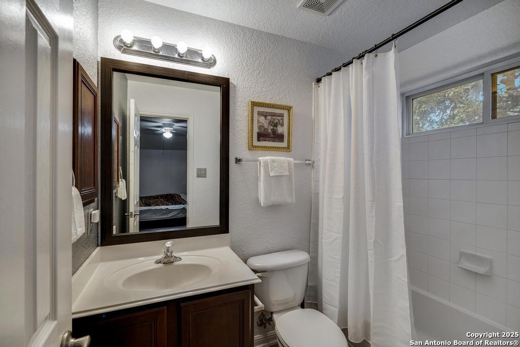 1934 Oak Flat Road San Antonio, TX 78251 - Photo 24 of 33 a bathroom with a sink vanity granite and toilet