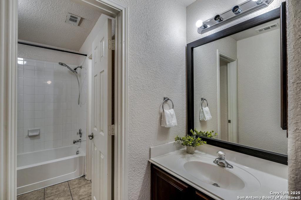 1934 Oak Flat Road San Antonio, TX 78251 - Photo 26 of 33 a bathroom with a bathtub shower sink and a mirror