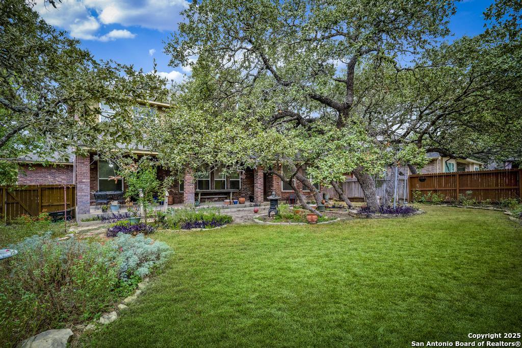 1934 Oak Flat Road San Antonio, TX 78251 - Photo 30 of 33 a view of a house with backyard porch and sitting area
