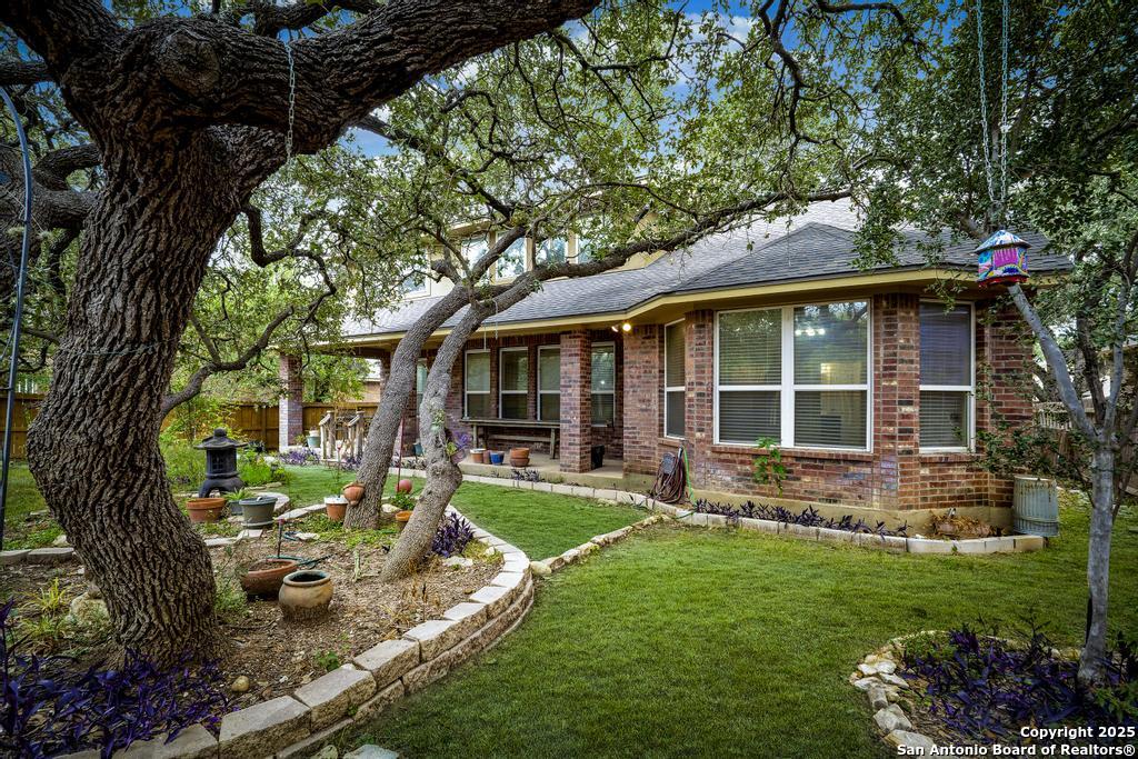 1934 Oak Flat Road San Antonio, TX 78251 - Photo 31 of 33 a view of a house with backyard sitting area and garden