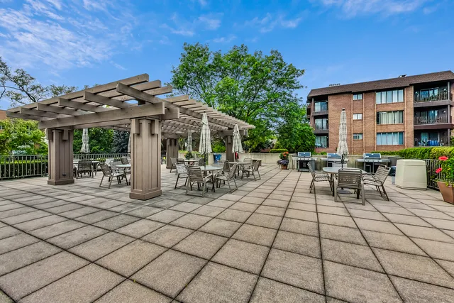 a view of a patio with dining table and chairs with a small yard