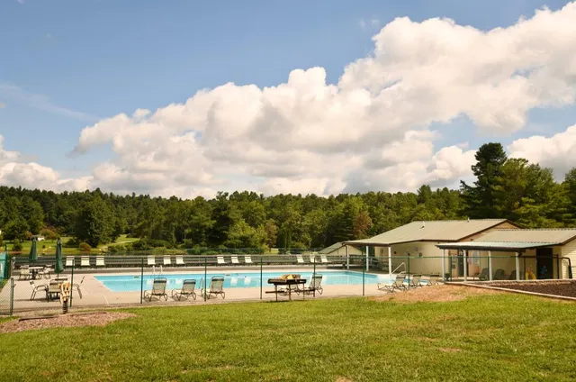 a view of house with outdoor space and seating area