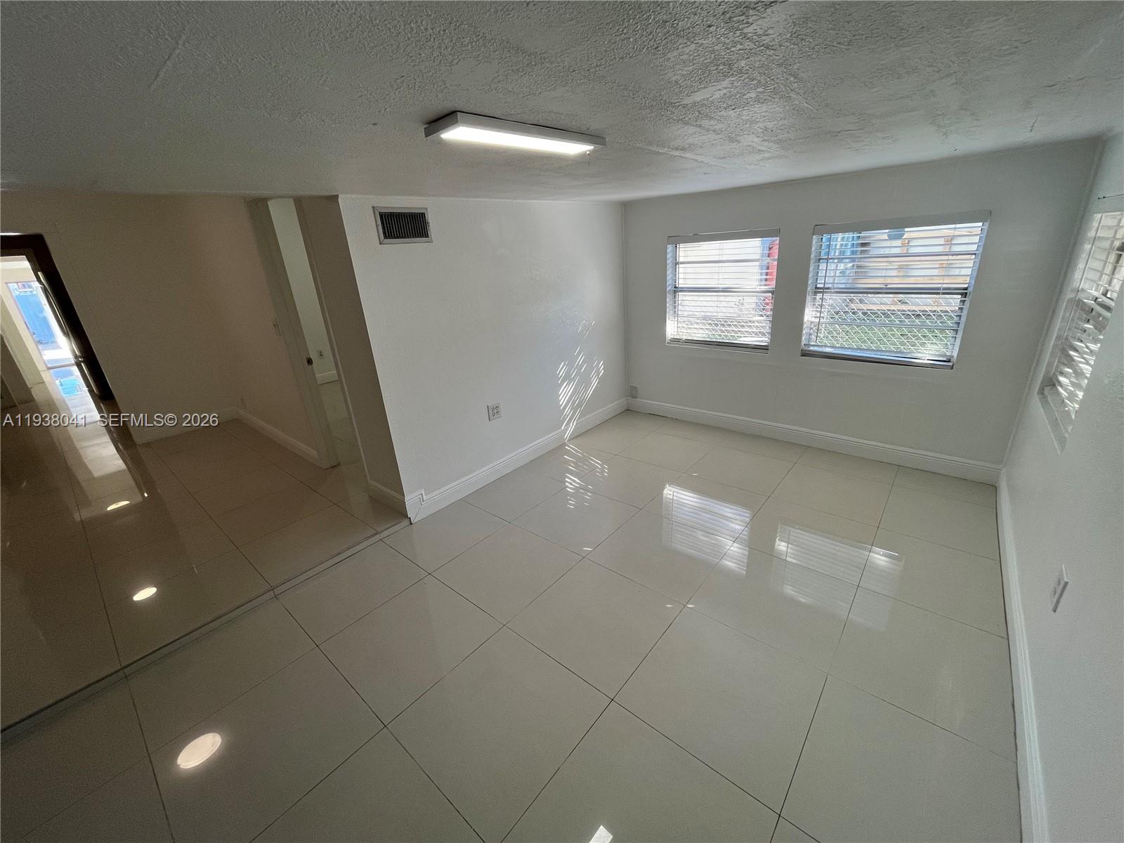 5803 Buchanan Street Hollywood, FL 33021 - Photo 12 of 14 a view of an empty room with windows