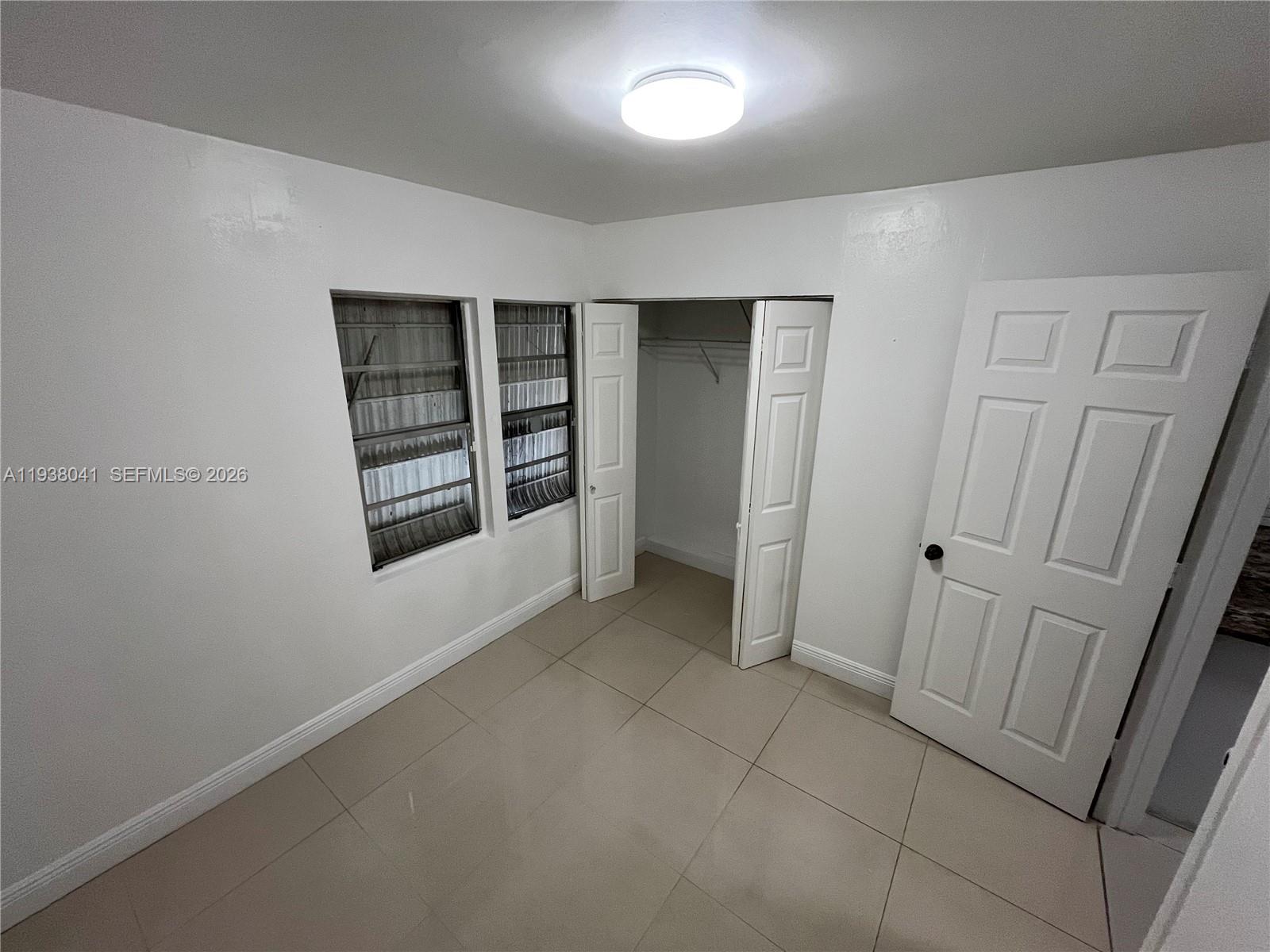 5803 Buchanan Street Hollywood, FL 33021 - Photo 13 of 14 an empty room with windows