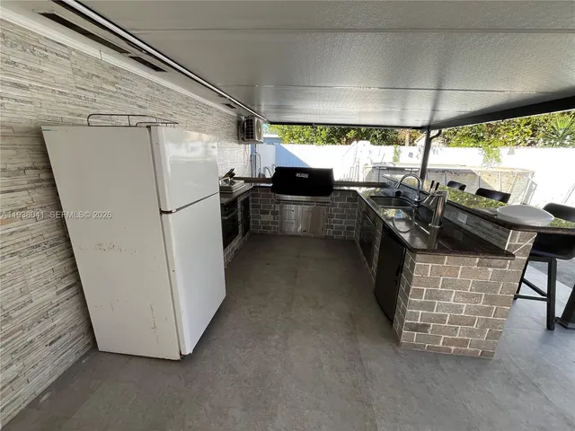a kitchen with furniture a refrigerator and a stove