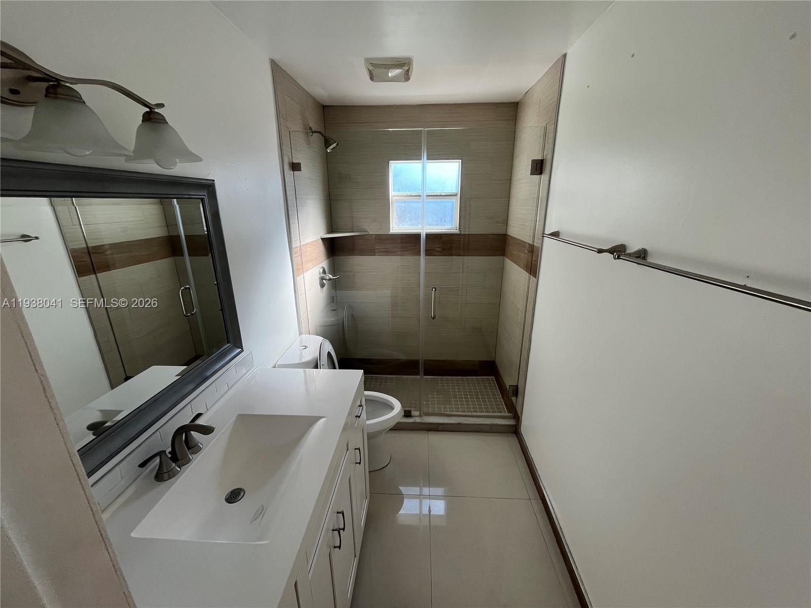 5803 Buchanan Street Hollywood, FL 33021 - Photo 4 of 14 a bathroom with a sink and mirror