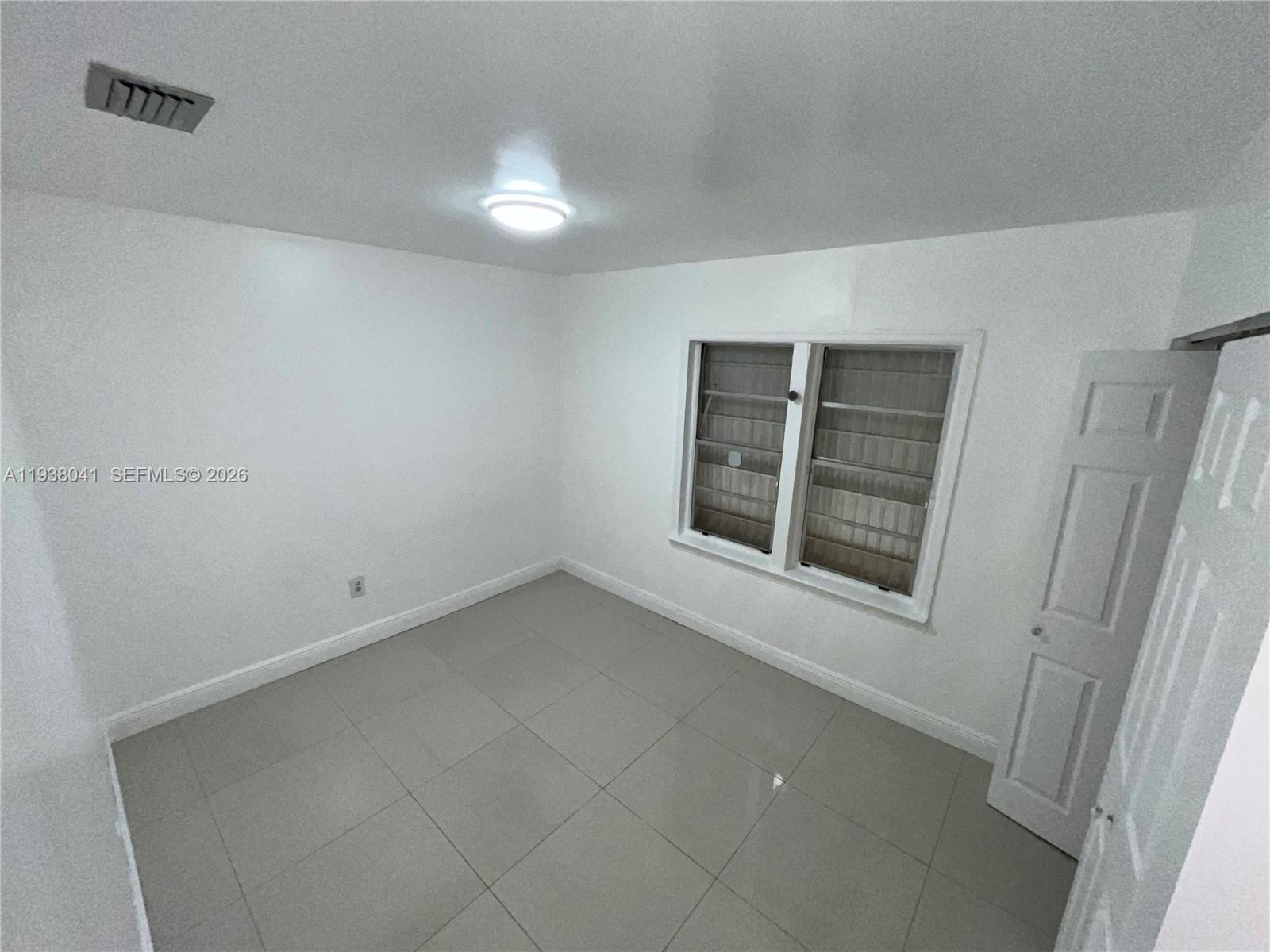 5803 Buchanan Street Hollywood, FL 33021 - Photo 8 of 14 a view of an empty room with a window