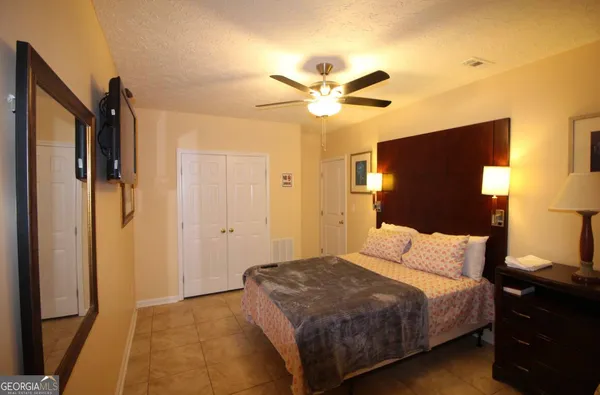 a bedroom with a bed and a chandelier