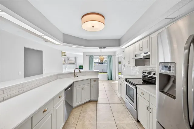 a kitchen with stainless steel appliances granite countertop a sink and cabinets