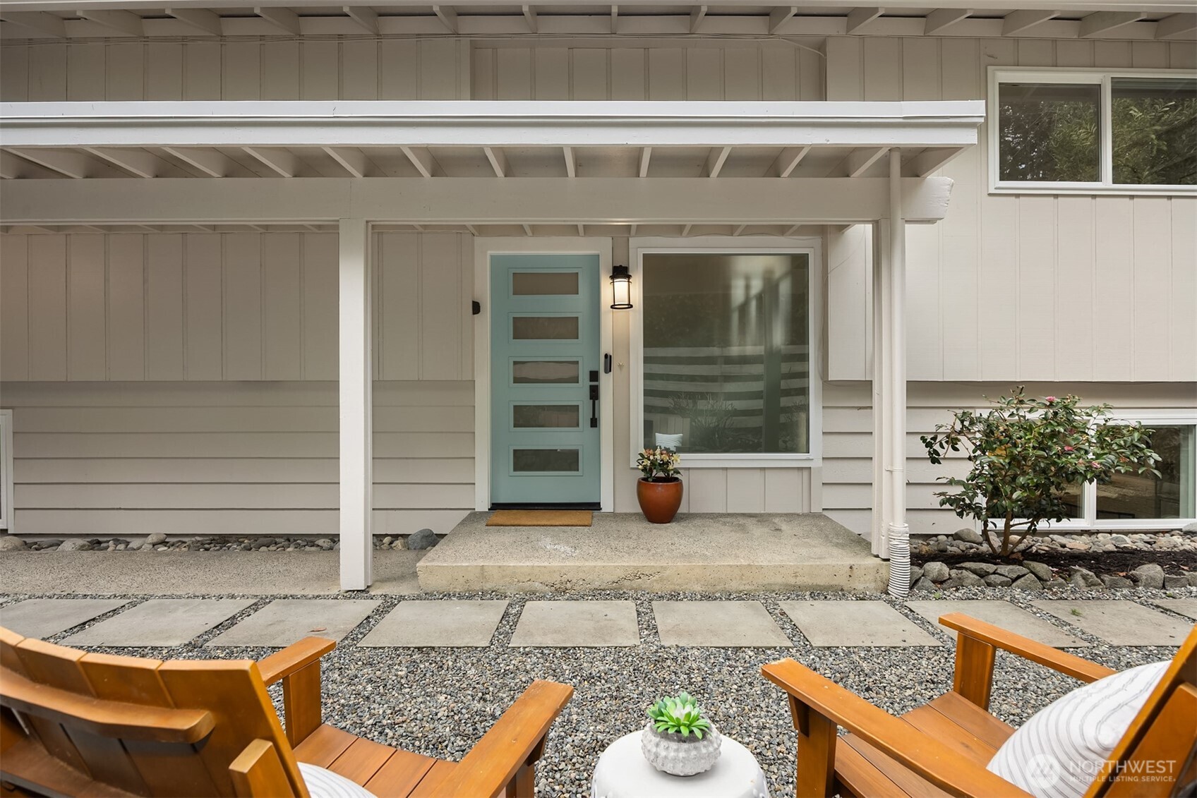 9280 Northeast Lovgreen Road Bainbridge Island, WA 98110 - Photo 1 of 40 a view of a patio with table and chairs and potted plants