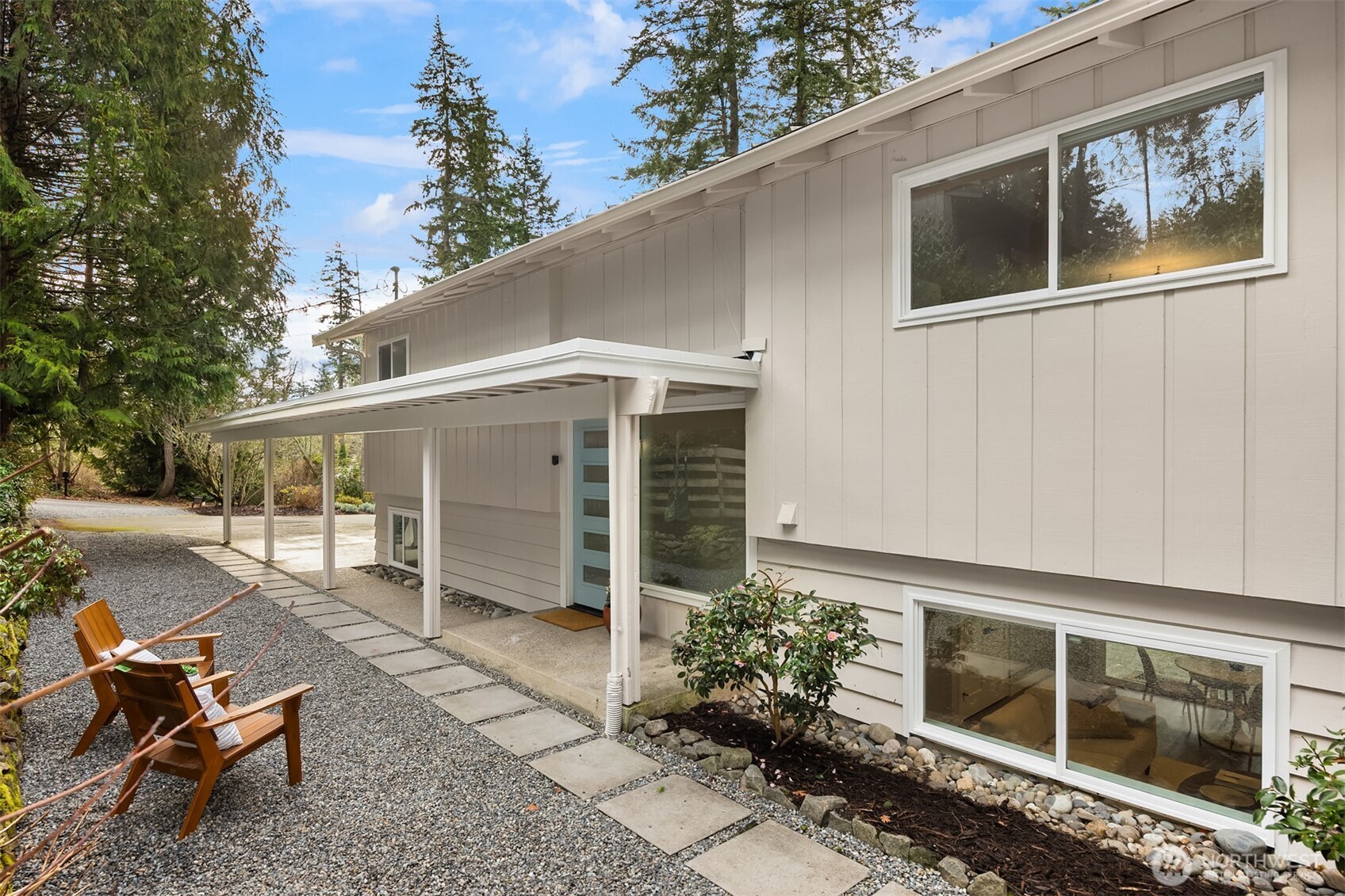 9280 Northeast Lovgreen Road Bainbridge Island, WA 98110 - Photo 30 of 40 a backyard of a house with yard furniture and garage