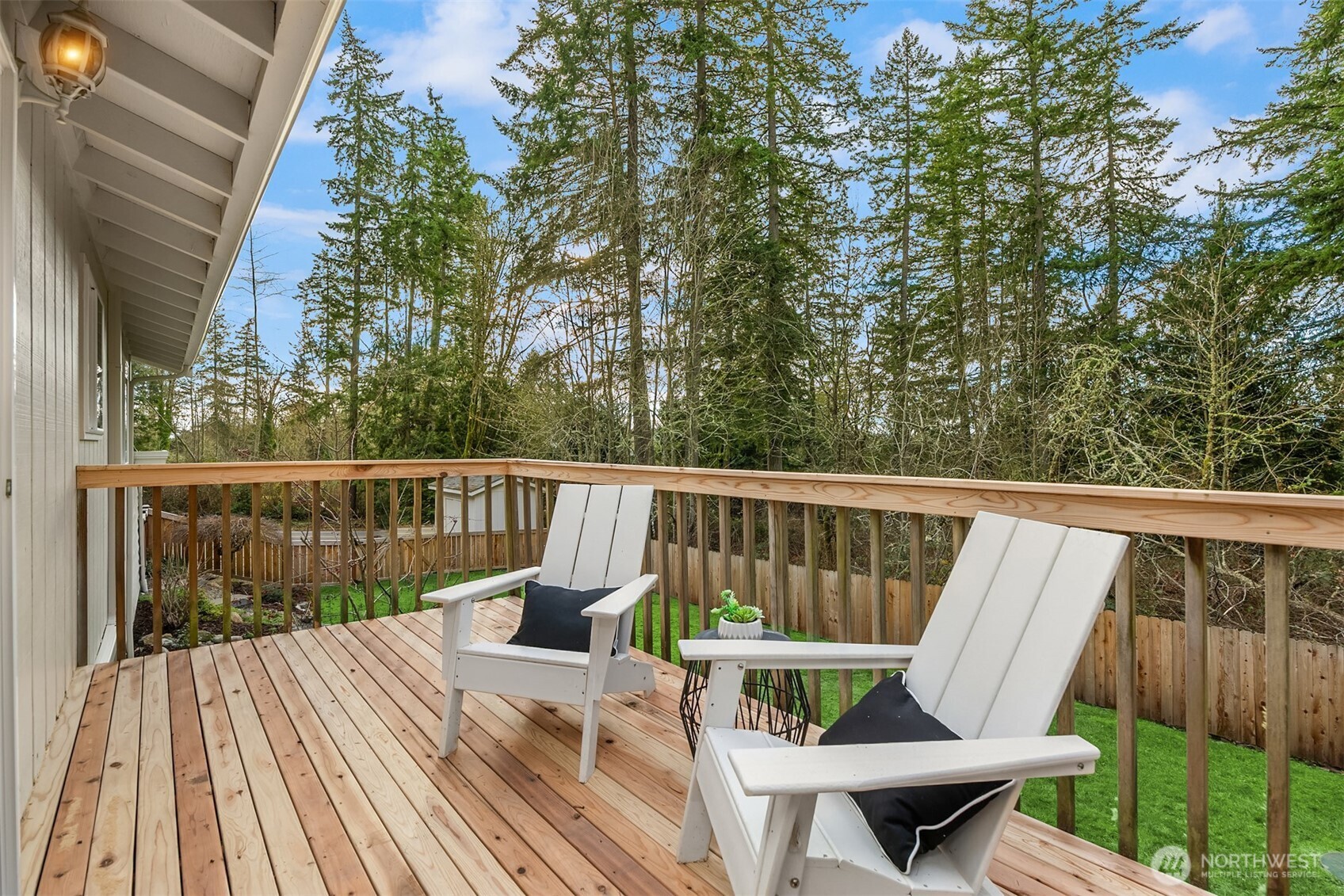 9280 Northeast Lovgreen Road Bainbridge Island, WA 98110 - Photo 8 of 40 a view of balcony with wooden floor and outdoor seating