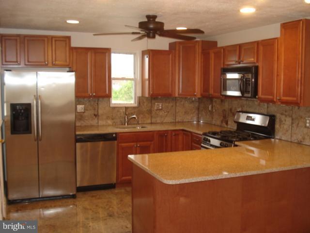 1833 Hanford Road Rosedale, MD 21237 - Photo 2 of 26 a kitchen with stainless steel appliances cabinets a sink and a counter top space