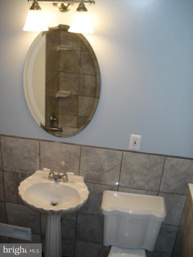 1833 Hanford Road Rosedale, MD 21237 - Photo 12 of 26 a bathroom with a sink and mirror
