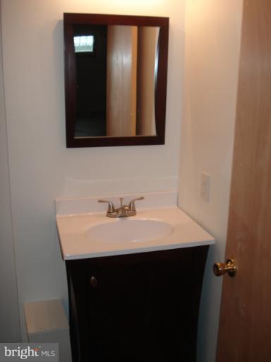 1833 Hanford Road Rosedale, MD 21237 - Photo 13 of 26 a bathroom with a sink and a mirror