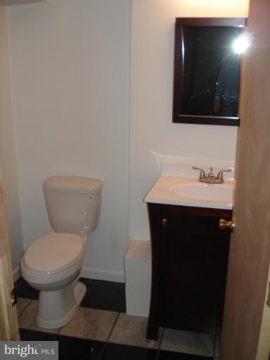 1833 Hanford Road Rosedale, MD 21237 - Photo 19 of 26 a bathroom with a toilet a sink and mirror
