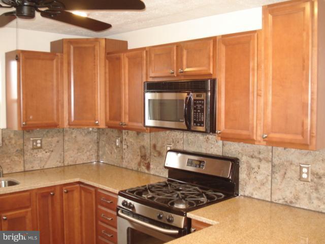 1833 Hanford Road Rosedale, MD 21237 - Photo 23 of 26 a kitchen with granite countertop a stove and a sink