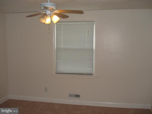1833 Hanford Road Rosedale, MD 21237 - Photo 4 of 26 a bathroom with a light fixture and a glass door