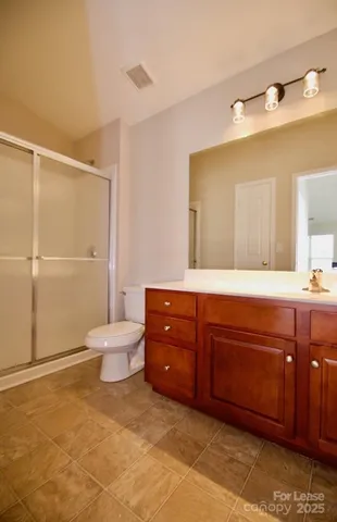 a spacious bathroom with a toilet sink and mirror
