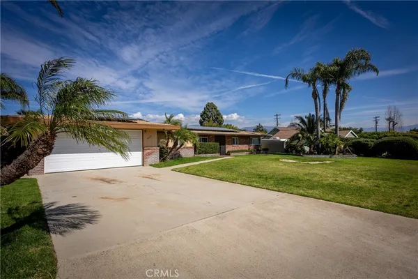 a front view of a house with a yard and a garage