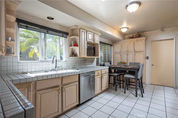 a kitchen with a sink and chairs